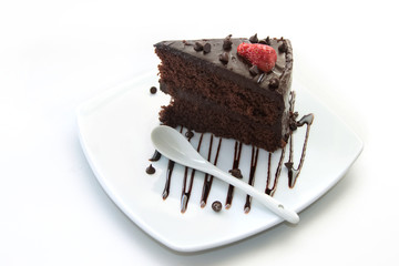 Slice of chocolate layer cake with  strawberries and chocolate s