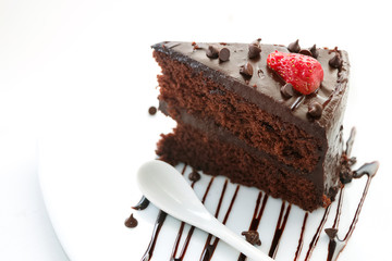 Slice of chocolate layer cake with  strawberries and chocolate s