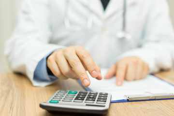 doctor is calculating cost of treatment