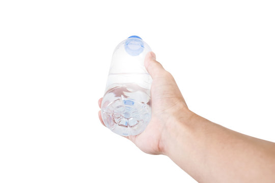 Hand holding, giving or receiving bottle of water, selective focus, isolated on white background