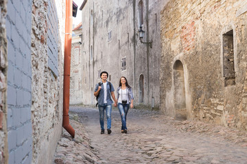 Young couple walking down a medieval street