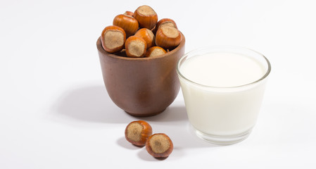 Glass of hazelnut milk isolated on white background. - 109425422