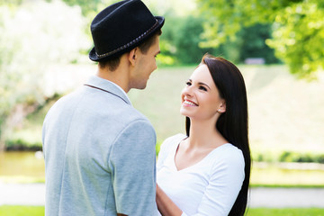 Fototapeta premium Young beautiful couple hugging in the park