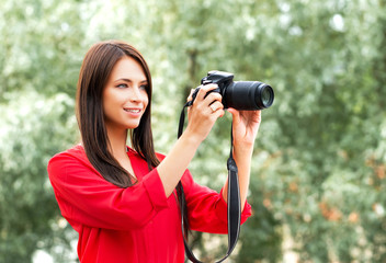 Young amateur female photographer with a dslr camera