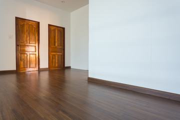 empty room, white mortar wall background and wood laminate floor