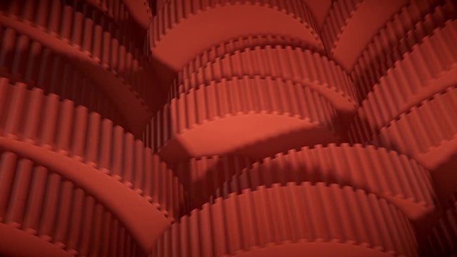 Looping orange array of small toothed gears.