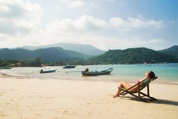 Beautiful, fit woman sunbathing in the deckchair