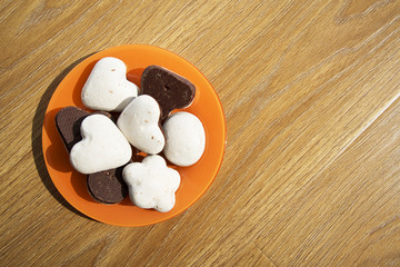 Cookies in an orange plate on a wooden table