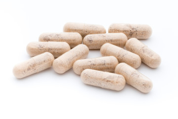 Ginkgo biloba capsule on the white background.