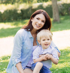 Gorgeous mother playing with her son in the park