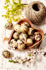 Spring easter composition with eggs and cherry flowers on a whiteold wooden  background 