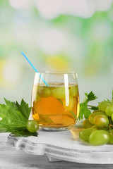 Grape and glass with juice on the table