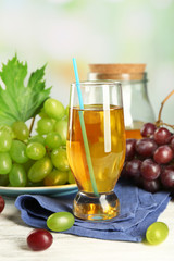 Glass with grape juice on blue napkin