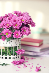 Beautiful flowers in vase on table in room