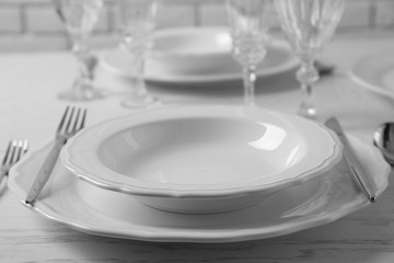 Table set at restaurant on light background
