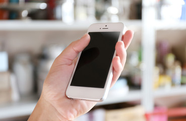 Woman holding smartphone indoors
