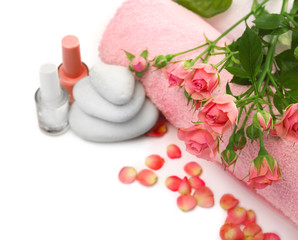 Fototapeta na wymiar Spa concept. Flower bouquet, towel and pebbles isolated on white background