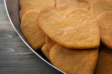 Heart shaped biscuits in baking tray, closeup