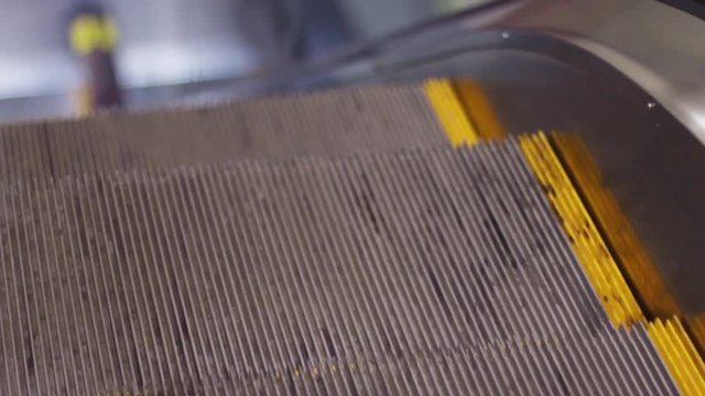 Close up view of moving stairs of grey modern escalator