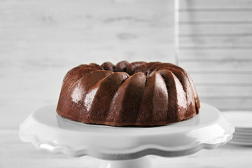 Chocolate cake on plastic mat on wooden background