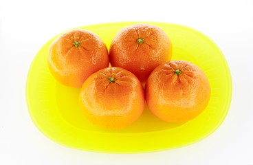 Tangerines on yellow plate