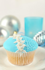 Tasty blue cupcake with decorations, closeup