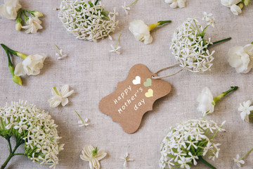 Happy Mother's day brown tag with White flowers background, selective focus, toning