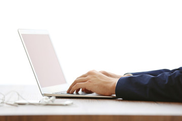 Man's hands using laptop at the table in office