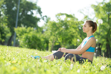 Naklejka na ściany i meble Woman meditating in park