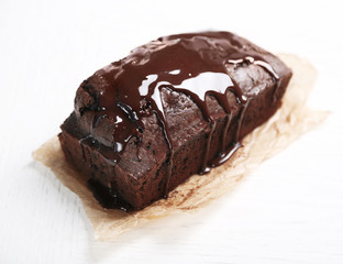 Chocolate cake with icing on white table