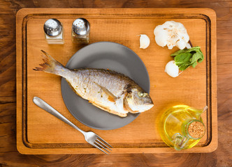 Vertical making whole roasted golden on plate, on wood