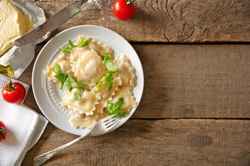 Cooked ravioli and tomatoes on plate
