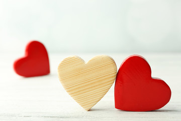 Wooden hearts on light background