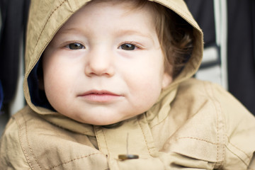 Cute baby on a walk. Autumn promenade. Headdress. A cap
