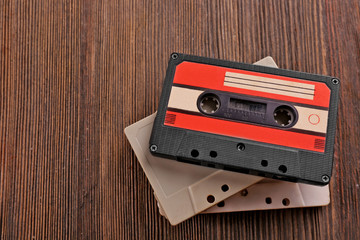 Old audio cassettes on wooden background