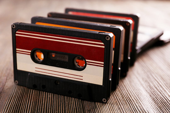 Set of old audio cassettes on wooden background