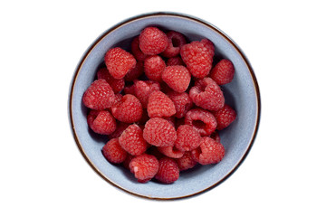 raspberries on blue ceramic bowl
