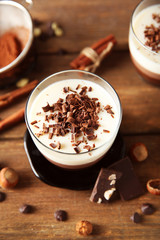 Layered desserts with decoration on wooden table