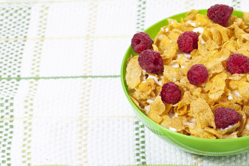 cropped image of bowl of cereal and raspberries