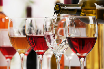 White wine pouring into glasses, closeup