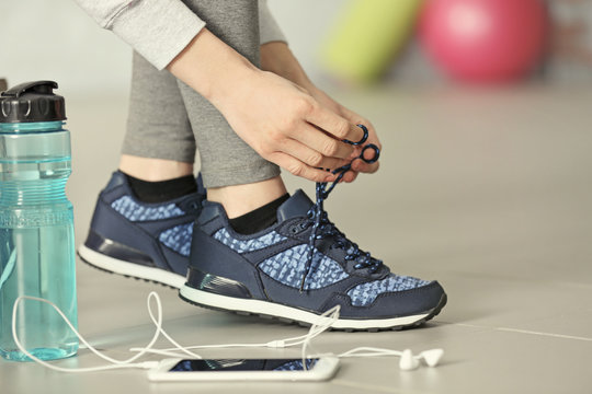 Woman Tying Up Running Shoe