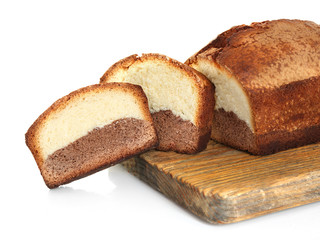 Delicious sweet cake bread on wooden cutting board isolated on white