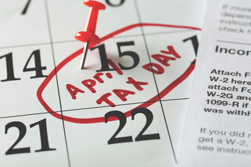 April tax day written and pinned in a calender, close up