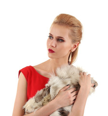 Fototapeta na wymiar Young beautiful blonde girl wearing perfect makeup and red dress posing in a fur over white studio background