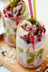 Healthy breakfast over night oats with fresh fruit kiwi and bananas in a glass jar. Beautiful oatmeal