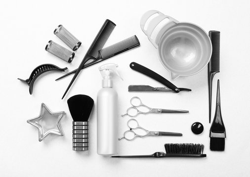 Barber set with tools, equipment and cosmetics on light background