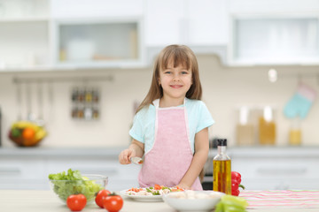 Obraz na płótnie Canvas Little girl with a plate of vegetable salad.