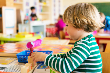 Indoor portrait of a cute little boy in a classroom