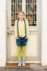 Fashion portrait of a cute little girl in a city © annanahabed