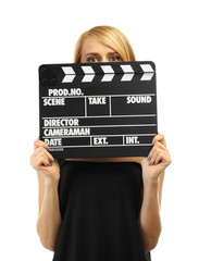 Young attractive woman holding film clapper isolated on white